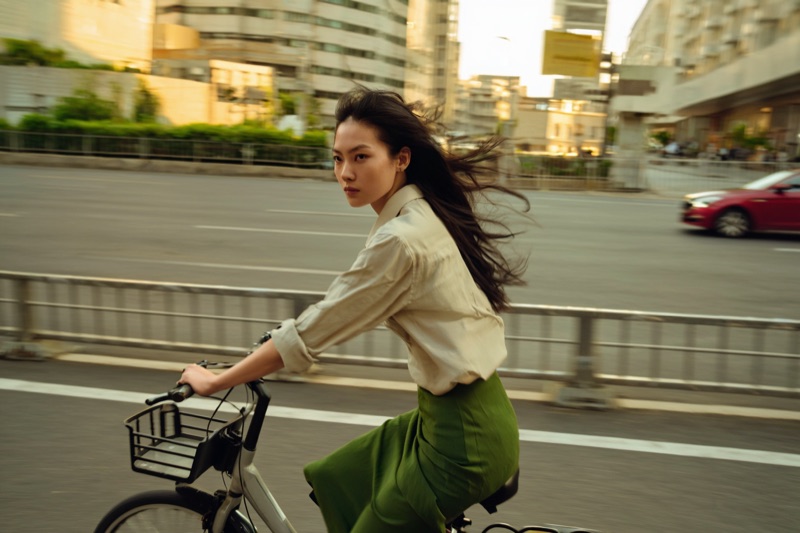 Lookback Ride · by NowhereManGo · bicycle, windswept hair, green midi skirt