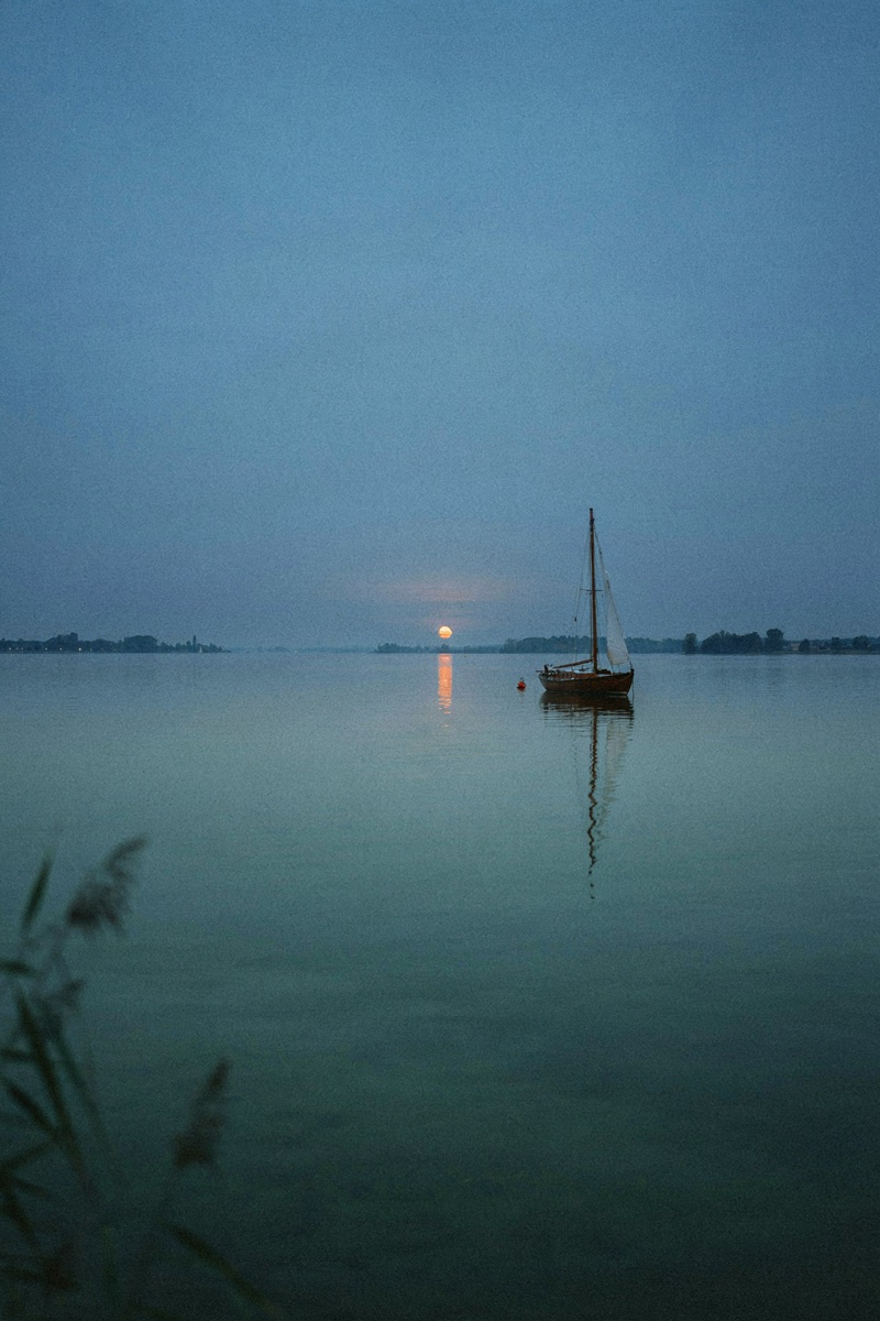 Sailboat at Dusk · by the_drot · wooden sailboat, still lake, blue hour