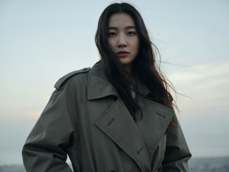 Olive Trench at Dawn · by NobodyButMeowie · olive trench coat, windblown hair, low-angle portrait