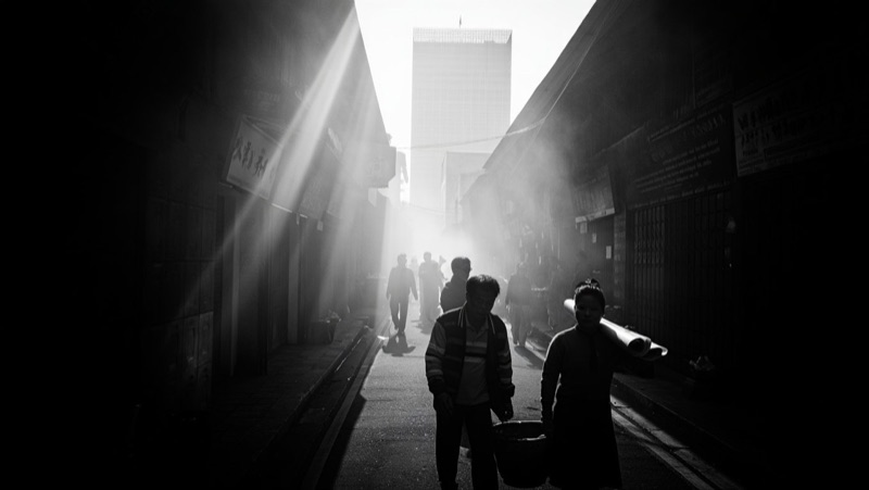 When the Sky Casts a Heavy Shadow · by Dinda Prasetyo · black-and-white city, street shadow, projected light